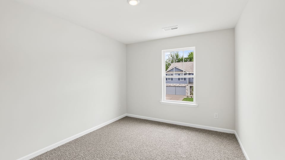 Loft with carpet and windows.