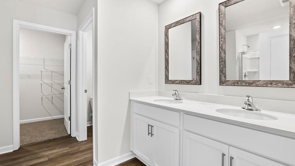 Primary bathroom with double vanity sinks.a