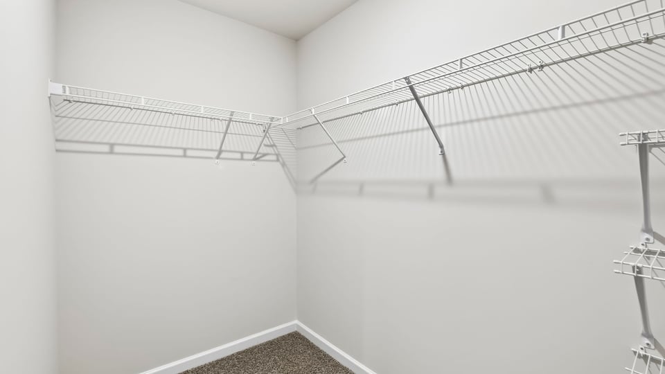 Primary closet with shelf.