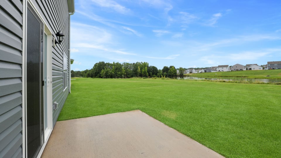 Back exterior with large backyard.