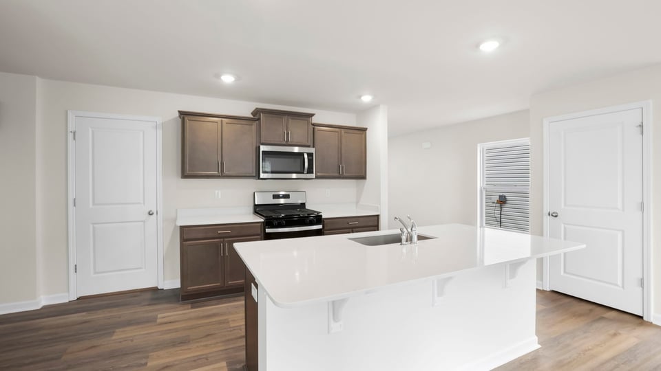 Kitchen with island and cabinets.