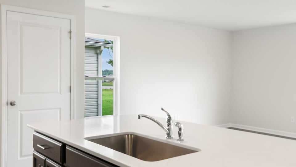 Kitchen with island and cabinets.