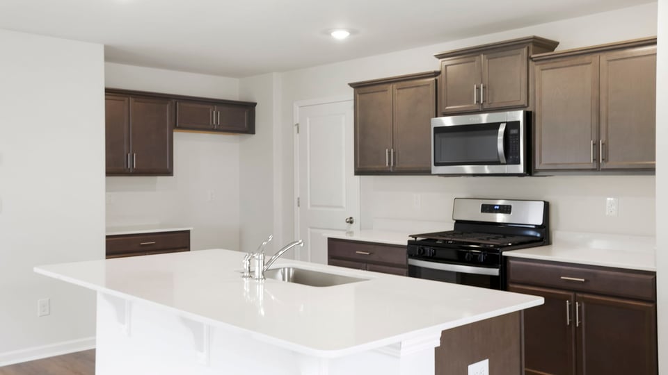 Kitchen with island and cabinets.