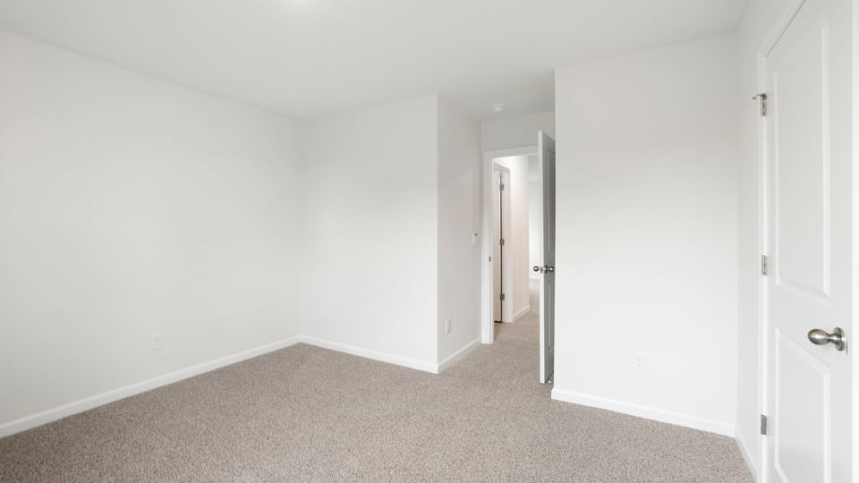 Bedroom with carpet and window.