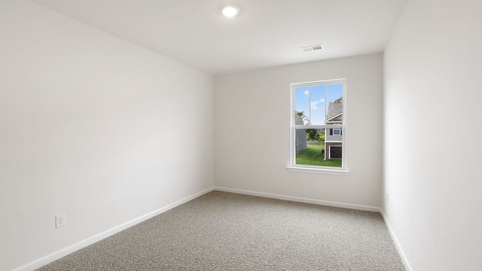 Bedroom with carpet and window.
