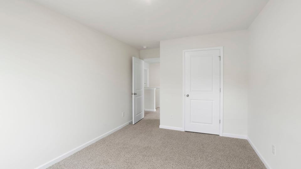 Bedroom with carpet and window.