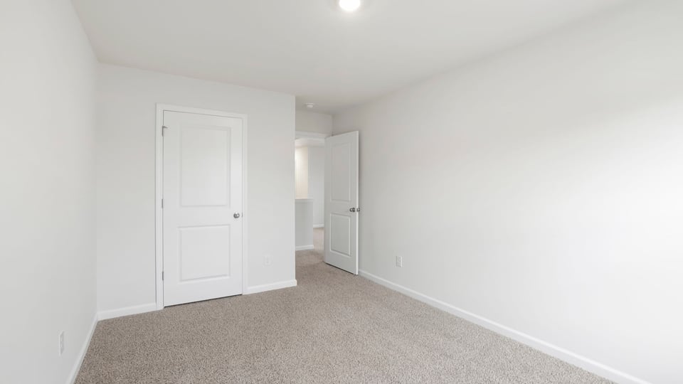 Bedroom with carpet and window.