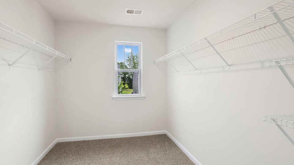Primary closet with shelf.