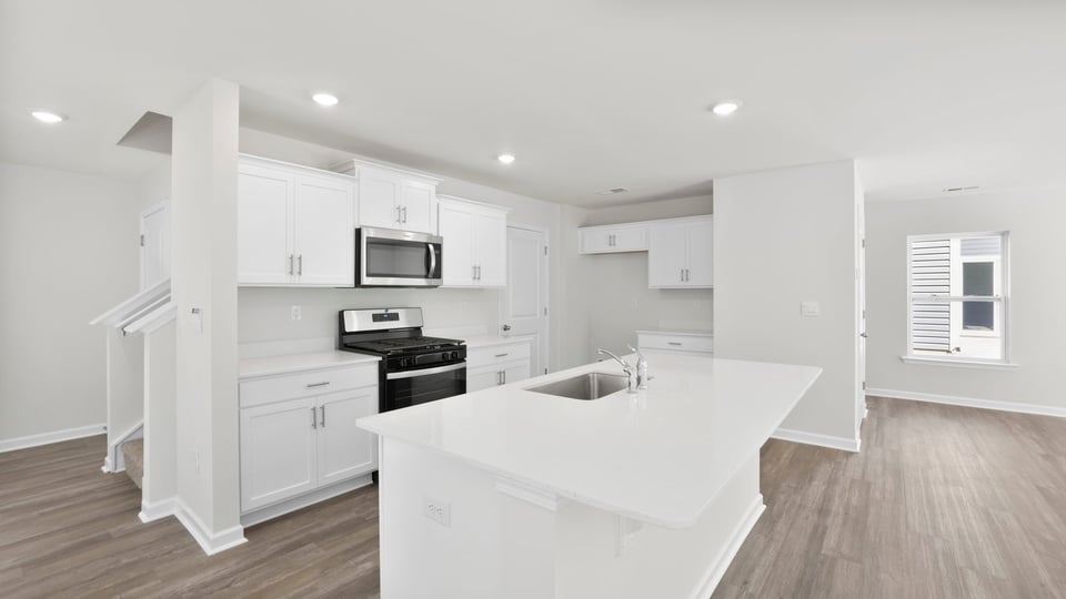 Kitchen and island with quartz countertops.