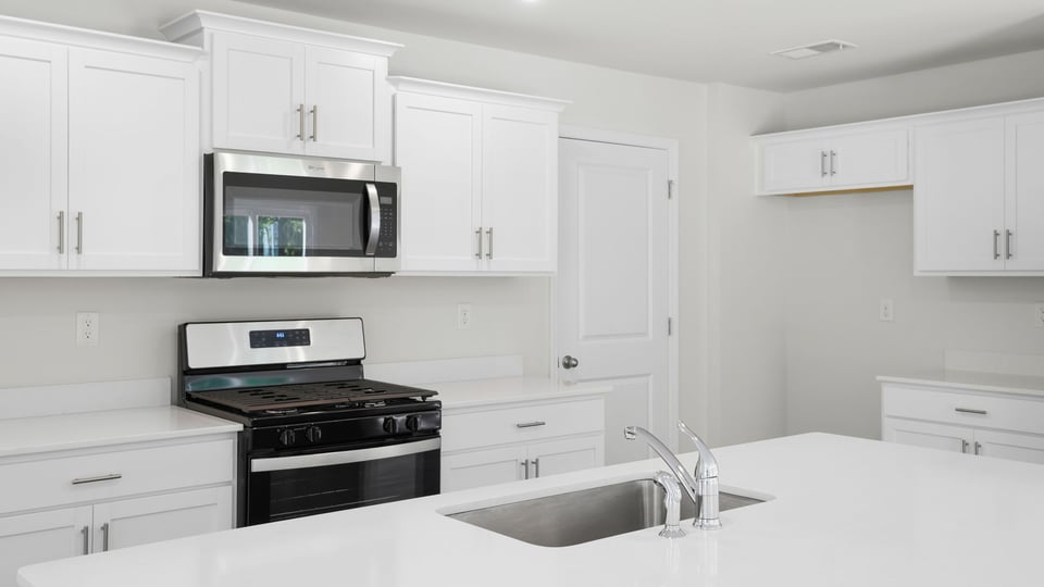 Kitchen and island with quartz countertops.