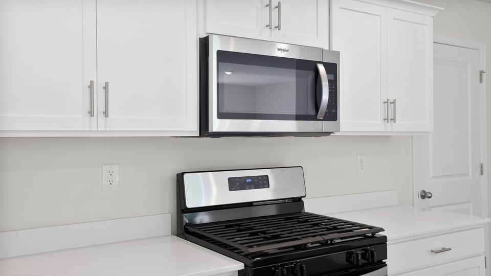 Kitchen and island with quartz countertops.