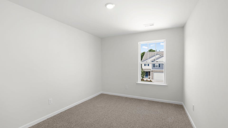 Bedroom with carpet and window.