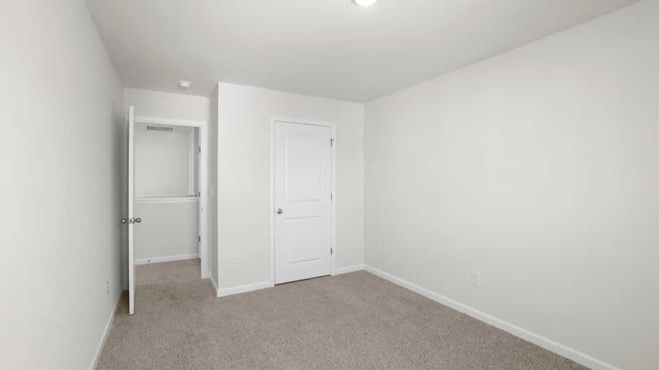 Bedroom with carpet and window.