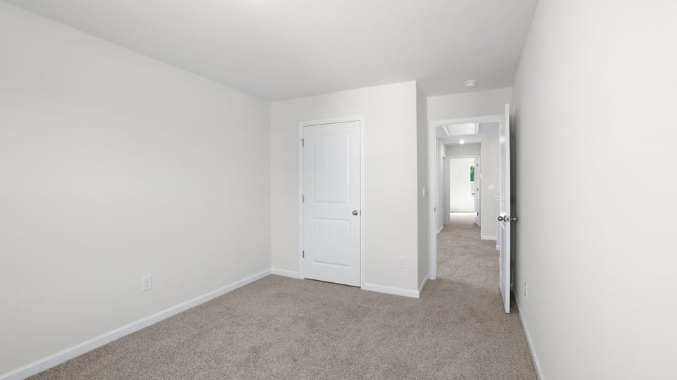 Bedroom with carpet and window.