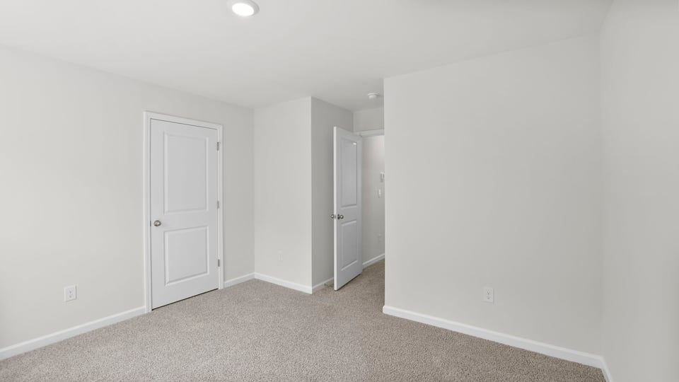 Bedroom with carpet and window.