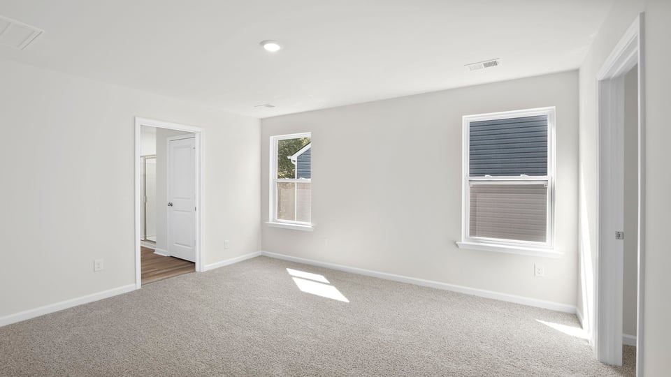 Bedroom with carpet and window.
