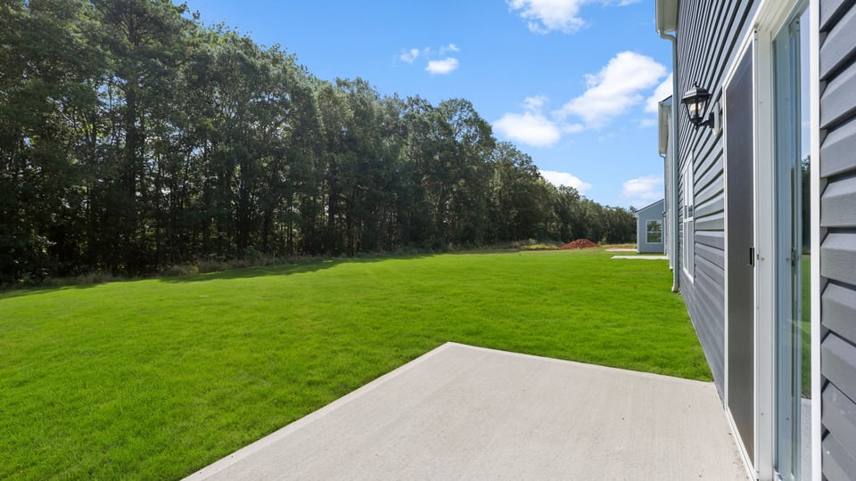 Back exterior of home with patio.