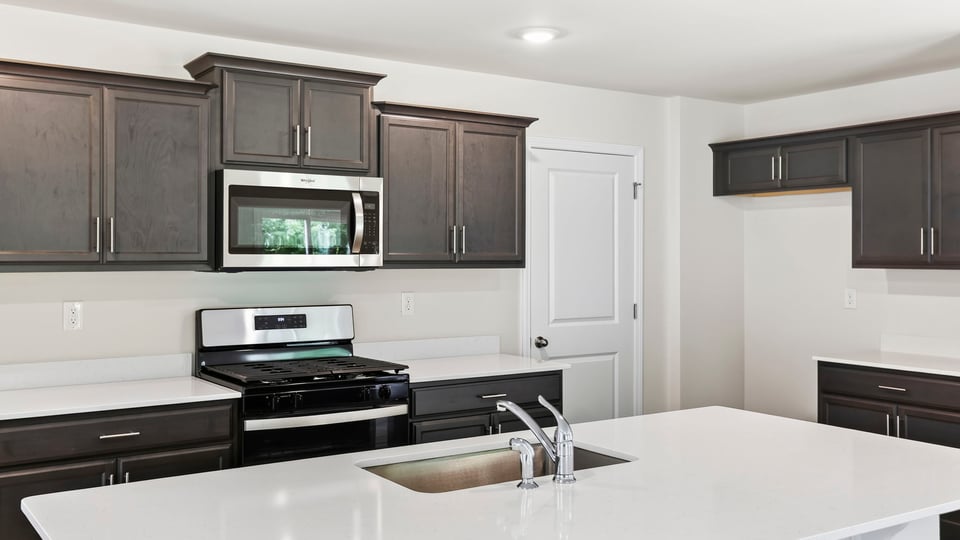 Kitchen with island and cabinets.