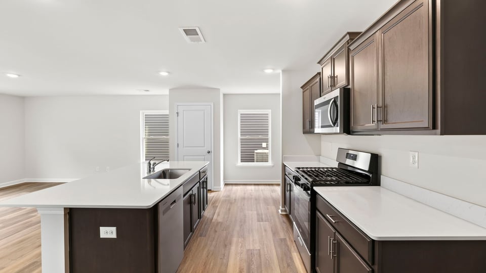 Kitchen with island and cabinets.