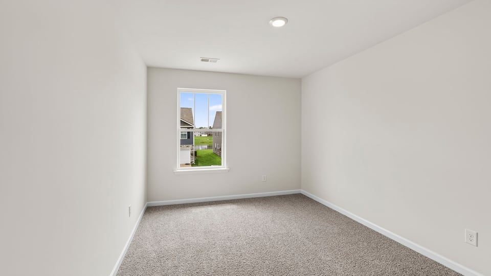 Bedroom with carpet and windows.