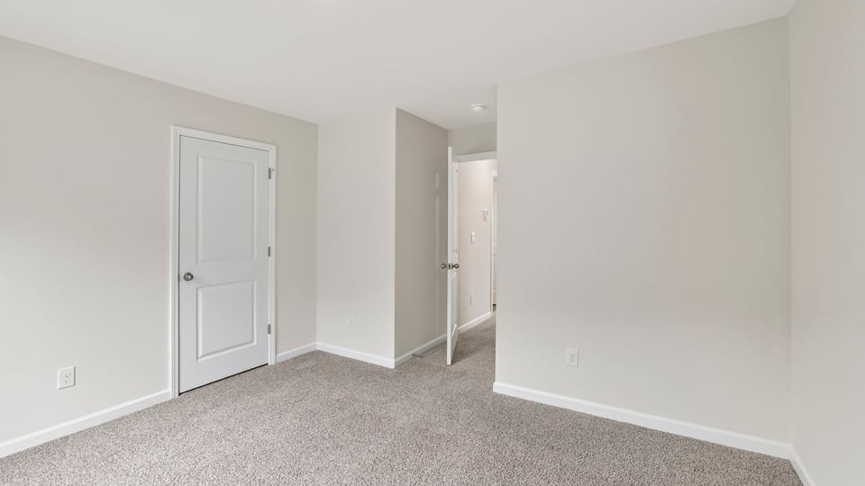 Bedroom with carpet and windows.