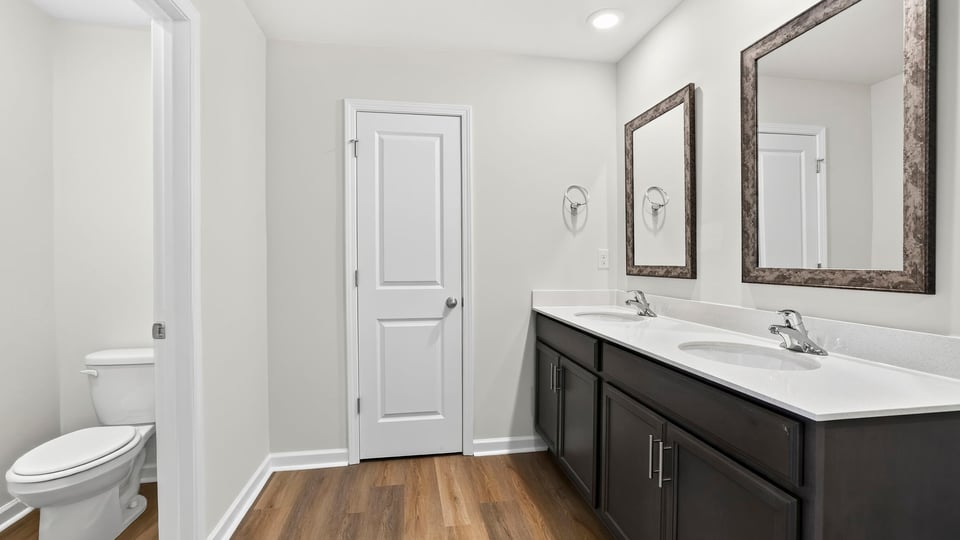 Primary bathroom with double vanity sinks.a