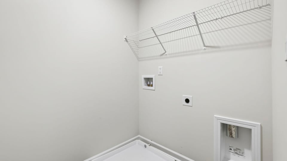 Laundry room with shelf.