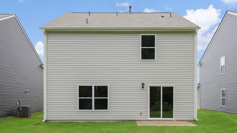 Back exterior with large backyard.
