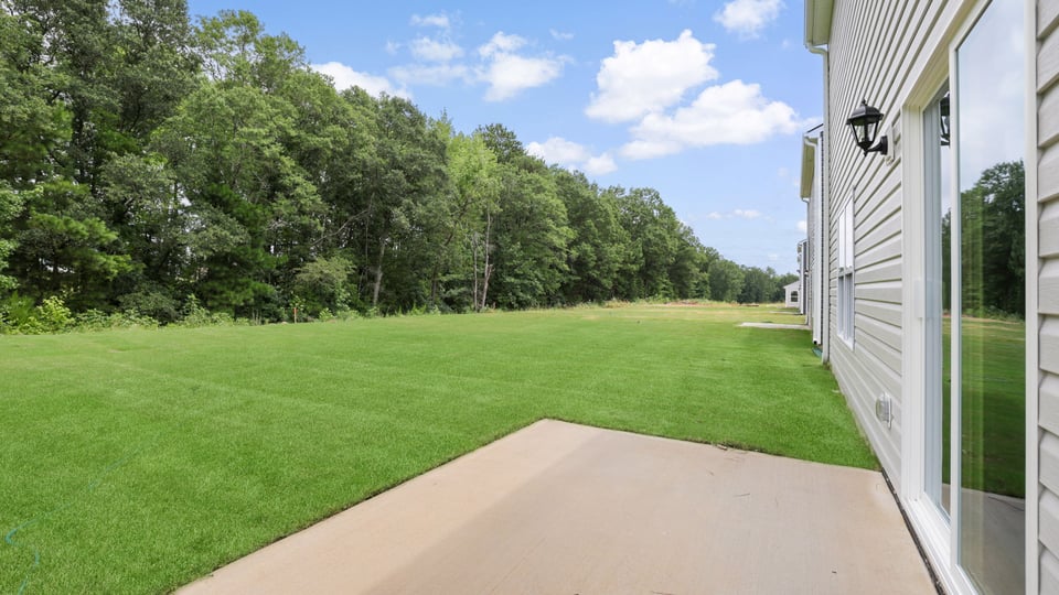 Back exterior with large backyard.