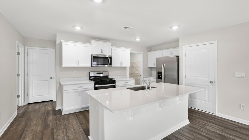 Kitchen with island and cabinets.