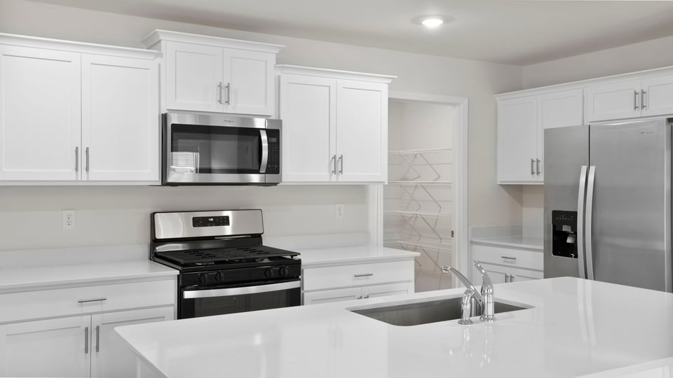 Kitchen with island and cabinets.