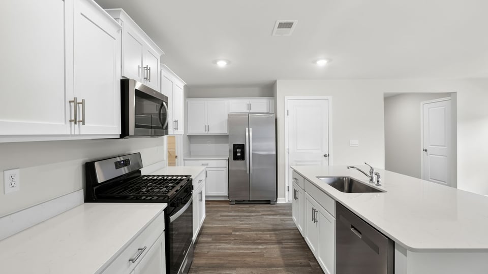 Kitchen with island and cabinets.