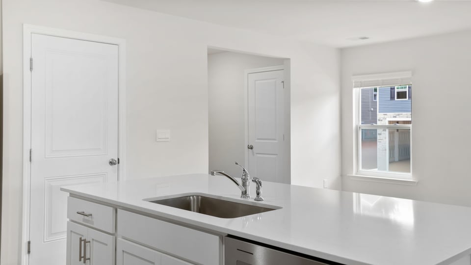 Kitchen with island and cabinets.