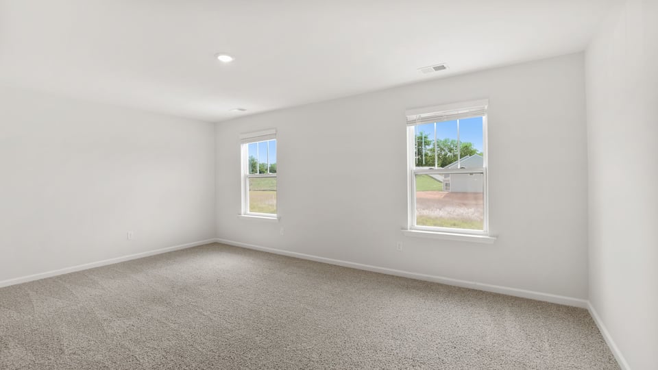 Bedroom with carpet and windows.
