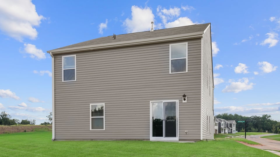 Back exterior with large backyard.