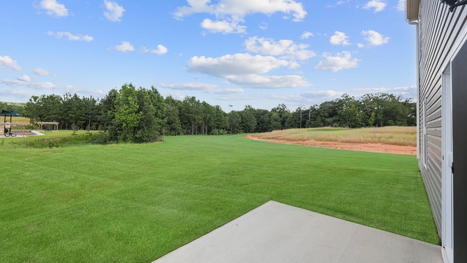 Back exterior with large backyard.