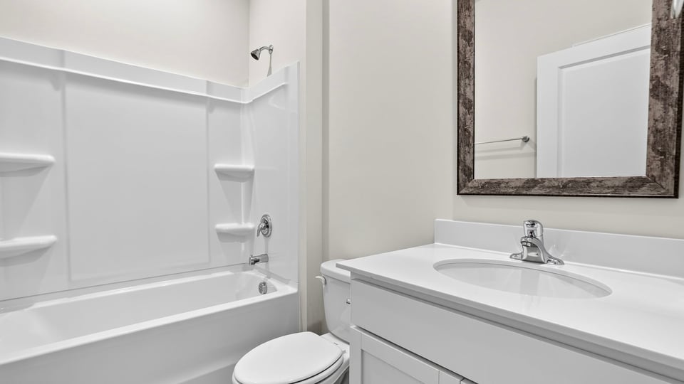 Bathroom with single vanity sink and bathtub.