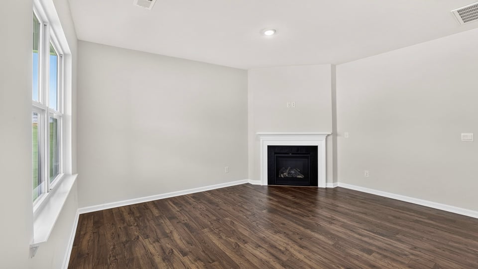 Family room with windows and fireplace.