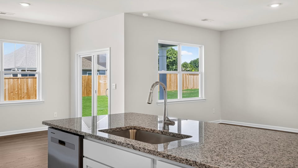 Kitchen and island with stainless steel appliances.