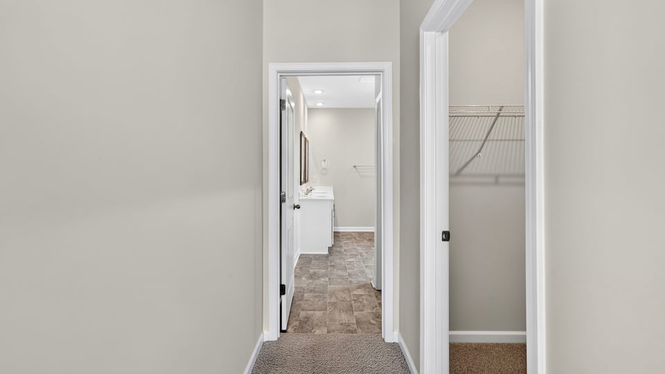 Bedroom with carpet and window.