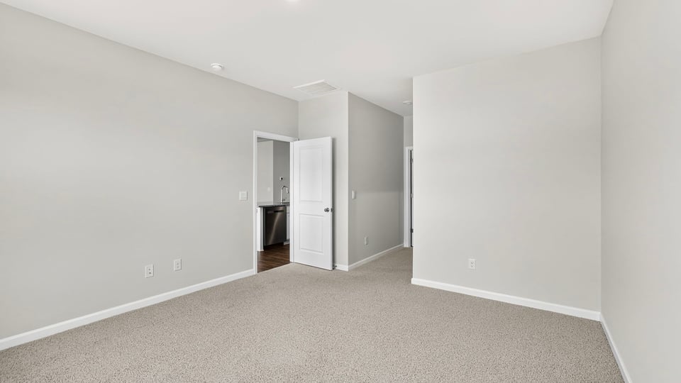 Bedroom with carpet and window.