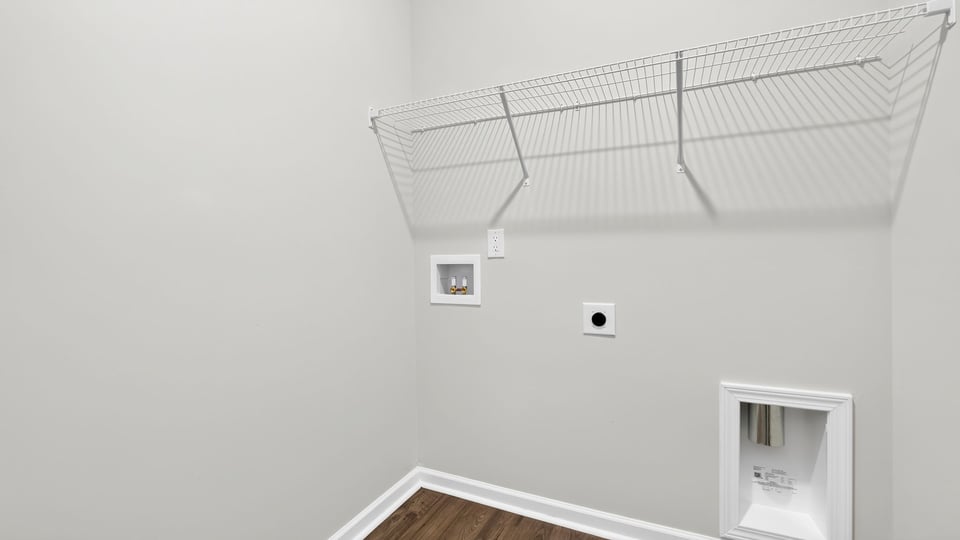 Laundry room with hanging storage racks.