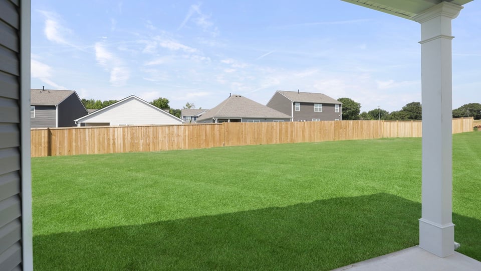 Back exterior of home with large backyard.
