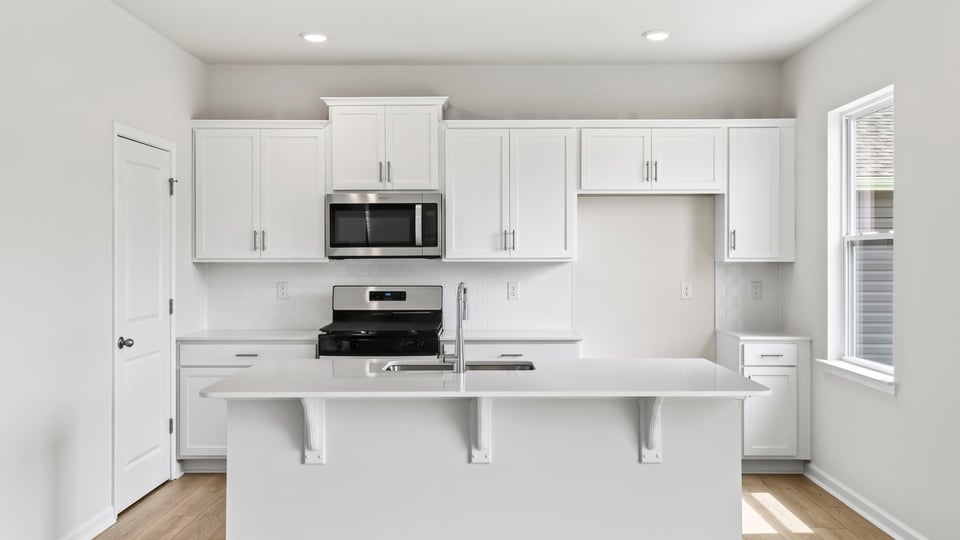 Kitchen with island and cabinets.