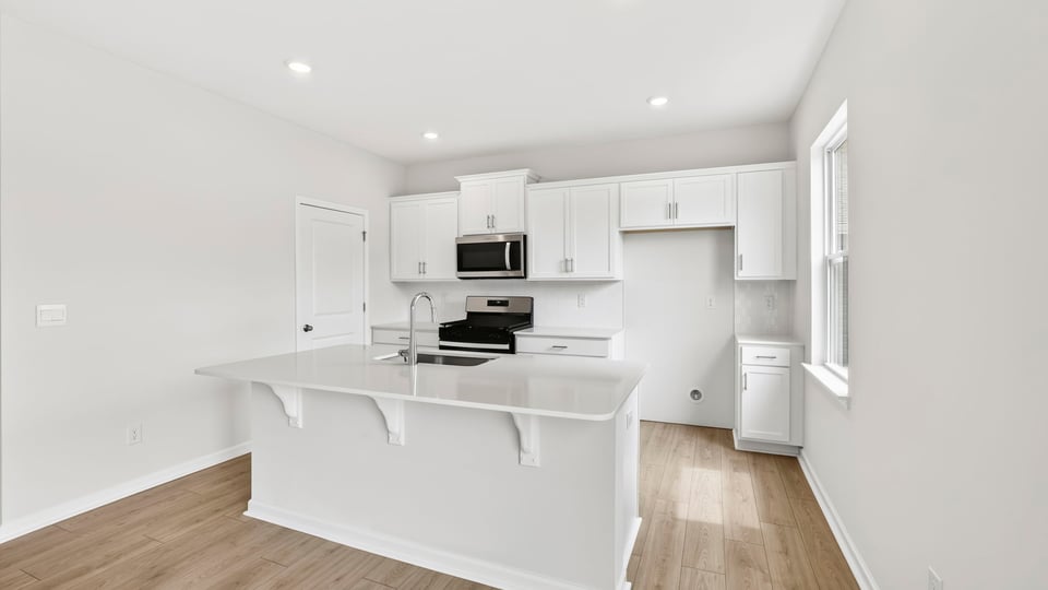 Kitchen with island and cabinets.