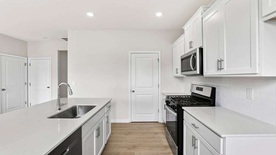 Kitchen with island and cabinets.