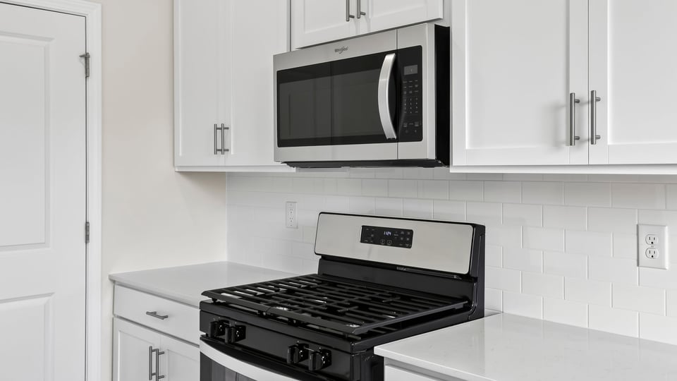 Kitchen with island and cabinets.