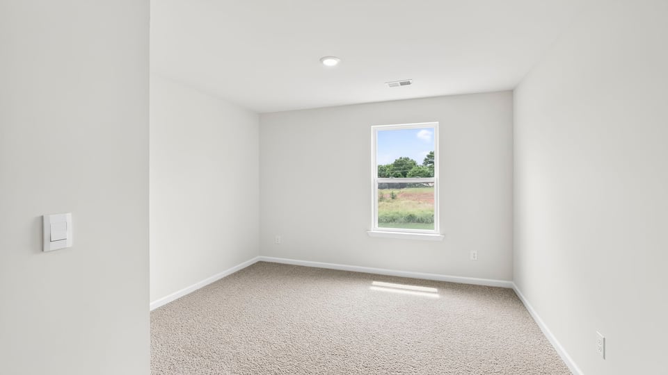 Loft area with carpet and window.