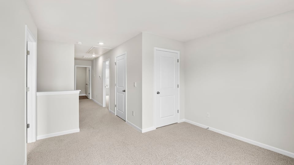 Loft area with carpet and window.