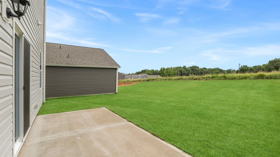 Back exterior with large backyard.